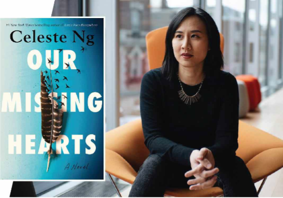 An Asian woman dressed in all black sits in an orange arm chair next to a row of glass window panes. Beside her is a book with a blue background with an image of a brown feather breaking apart at the top into small birds. The book is titled, “Celeste Ng OUR MISSING HEARTS: A Novel.”