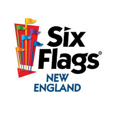 The image is the logo for Six Flags New England. The logo features the name "Six Flags" in bold black text, with colorful flags rising from the left side of the text. Below "Six Flags," the text "New England" appears in blue.