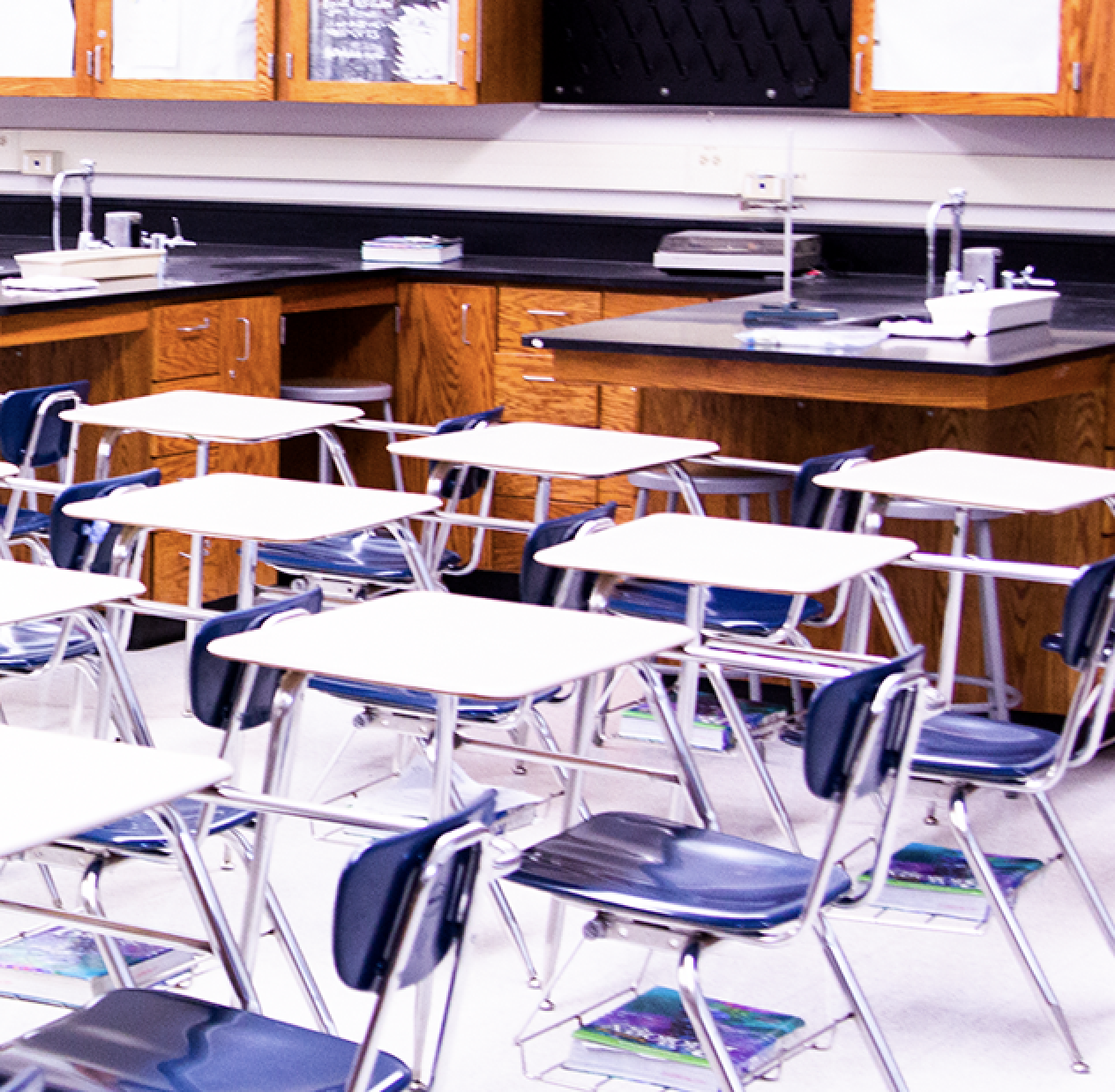 An image of a classroom with empty desks.