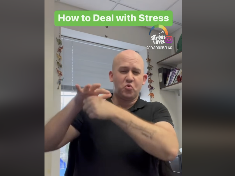 Thumbnail of a white bald man signing “Stress” in ASL with a green box with a white title “How to Deal with Stress” above his head.