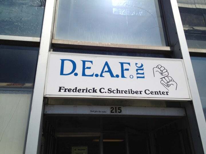 The entrance of the previous DEAF, Inc. headquarters on 215 Brighton Ave with the organization’s former logo displayed above the door.