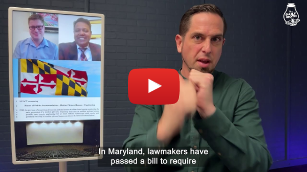 Maryland to become second state to require movie theaters to provide open captions - A white man stands in front of a grey background signing. An image to his left shows two men and the Maryland flag. White Daily Moth logo in upper right corner. Red Youtube logo in middle